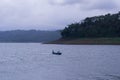 WONOSOBO, INDONESIA Ã¢â¬â JUNE 19, A fisherman who was sailing looking for fish in the middle of the lake